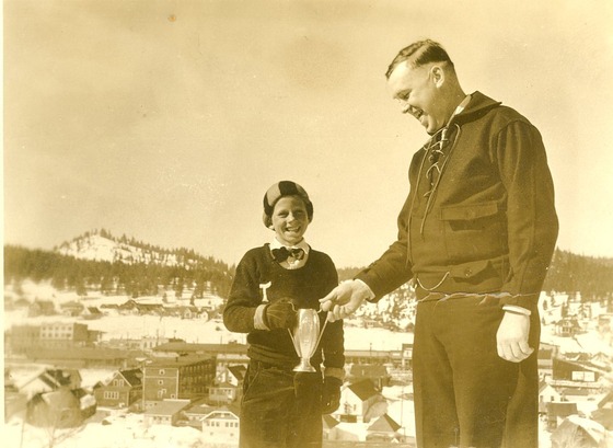 Bert Cassidy awarding Jack Sanders a trophy for skiing in 1932