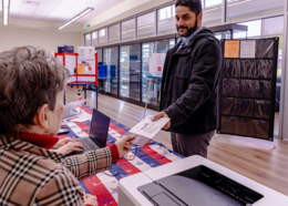 Election aide helps resident at voting center