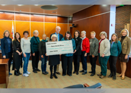 Library Friends holding check
