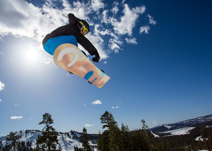 Snowboarder performing trick in the air