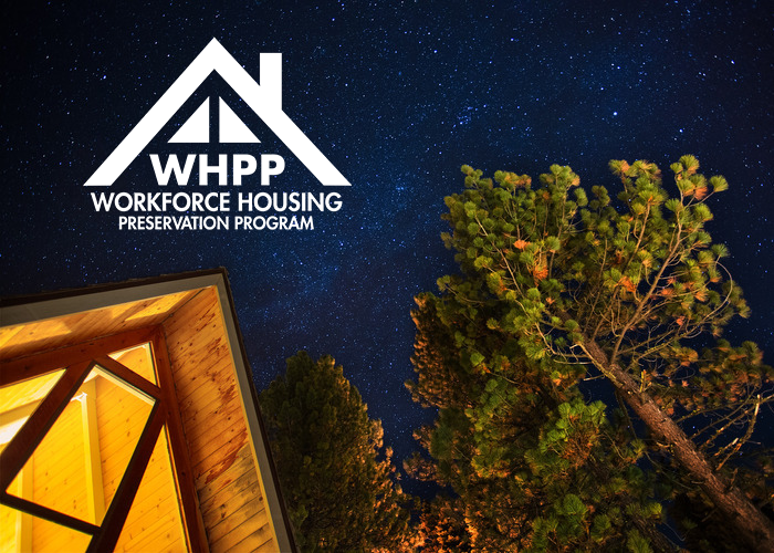 A view of stars above an a-frame cabin in North Lake Tahoe with the WHPP program badge. 