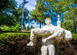 Veteran holding deceased veteran- statue