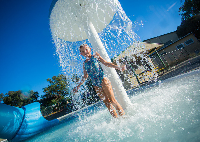 Fun things this week banner girl standing underneath water park attraction 