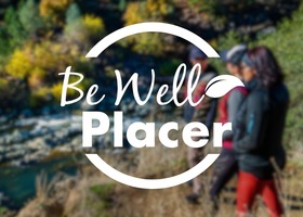 be well placer logo on image with people on hike trail