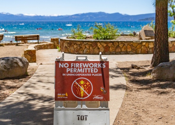 A sign at a Lake Tahoe beach stating no fireworks are permitted in unincorporated Placer
