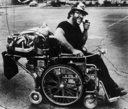 Picture of Robert Brewster on his motorized wheelchair 1980