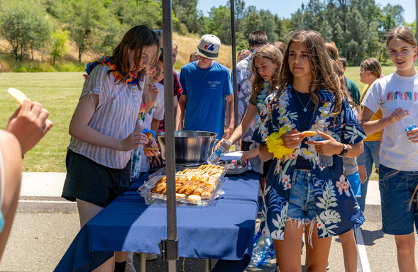 image of kids getting snacks from Newcastle ribbon cutting