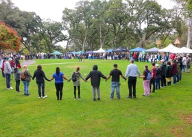 Large circle of people holding hands