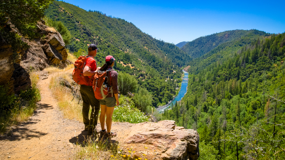 Hikers on trail near river