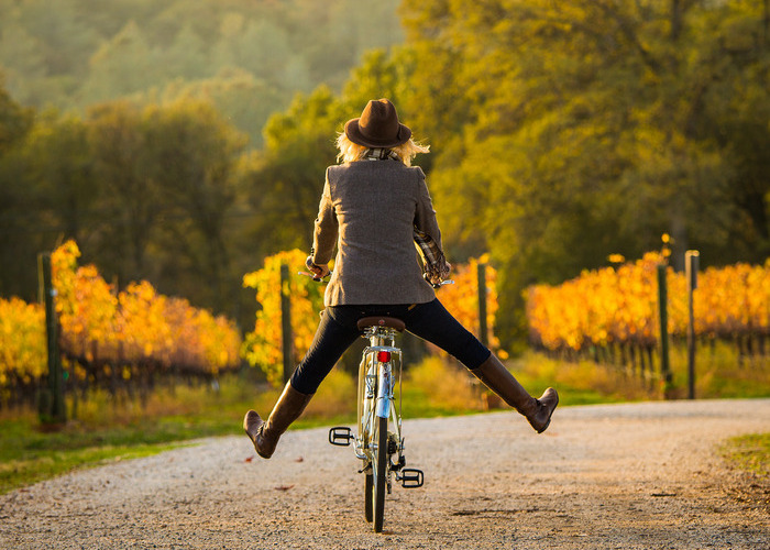 Man on bike with legs off pedals