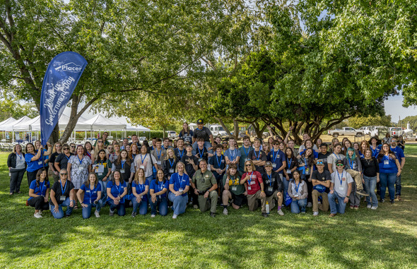 A group photograph outdoors on a sunny day with dozens of high school students and employees of Placer County