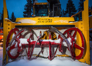 A front-end view of a snow blower machine.