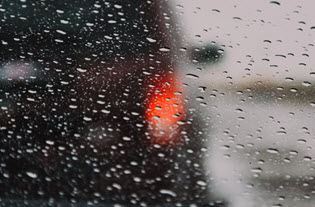 Winter weather tips on an image of a wet window and car taillights.