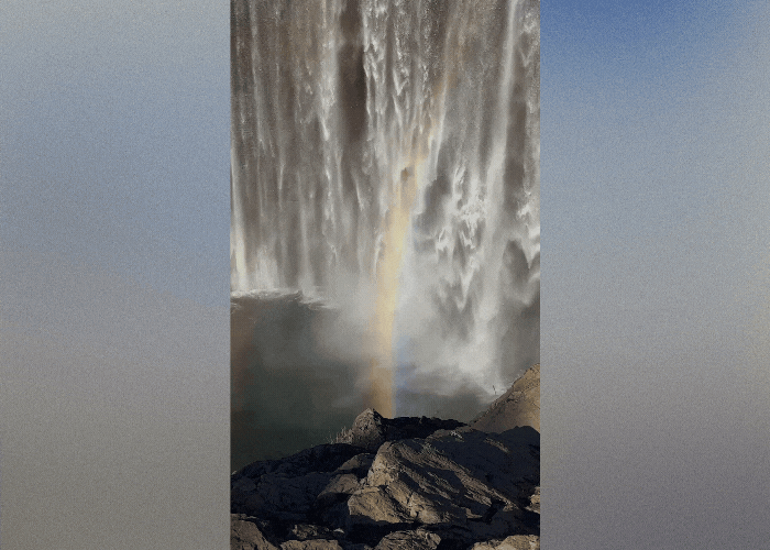 A rainbow filters through a waterfall 