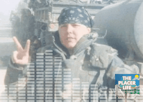 An animated graphic shows sound waves over a soldier in uniform giving the peace sign