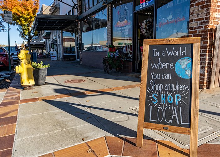 A sign in Lincoln states: In a world where you can shop anywhere, shop local.