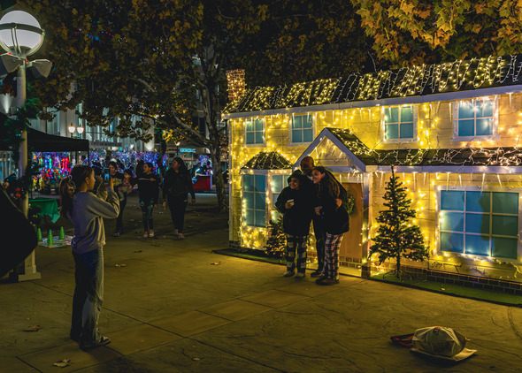 People taking a photo in front a decorated house