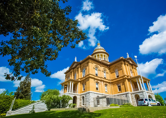 Exterior of the Historic Auburn Courthouse and sheriff’s patrol vehicle on a sunny day