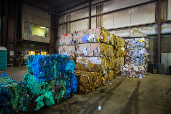 An image of blue bags and recycled bundles inside the eastern Placer materials recovery facility.