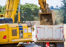 An image of two construction vehicles moving dirt. 