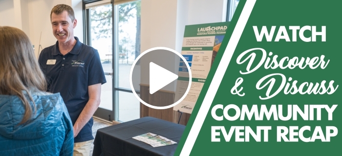 An image of a Placer employee smiling at an attendee at the Discover & Discuss community event with a play button overlay.