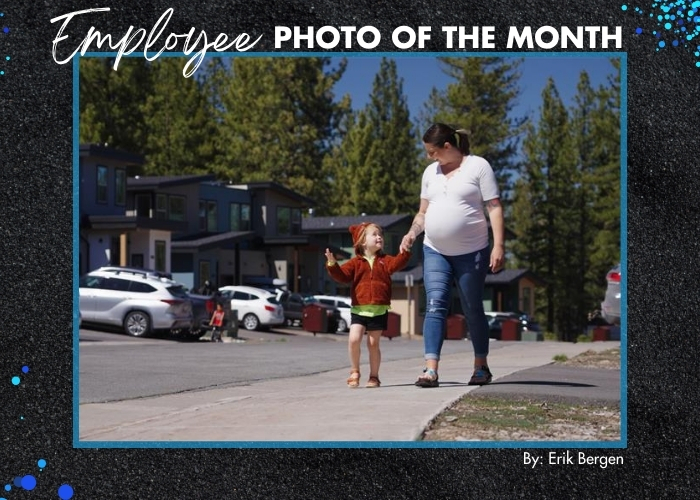 Employee Photo of the Month - An image of a mother and child walking along the sidewalk in Hopkins Village in North Lake Tahoe.