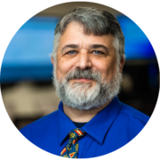 A profile image of Dave Atkinson in a blue collared shirt and tie.