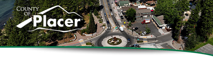 An image of a Kings Beach roundabout and trees from the sky with the county logo.