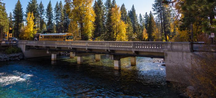 An image of Fanny Bridge with a yellow bus passing on it.  