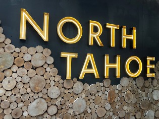 An image of the yellow-lights of the North Tahoe sign at the North Tahoe Event Center. 
