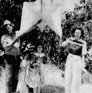 A black-and-white photograph of the Rodger family holding a big weather balloon. 