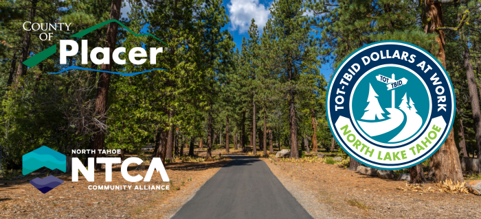 An image of a trail in North Lake Tahoe with black pavement, yellow brush to the sides and green trees with the TOT-TBID Dollars at Work logo.