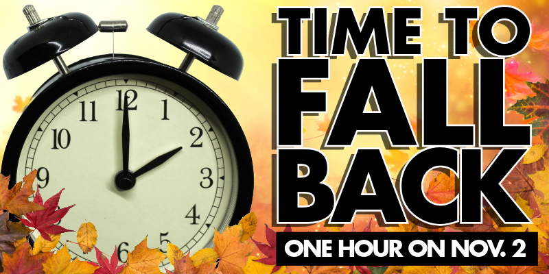Clock surrounded by fall leaves, text overlay: time to fall back one hour on Nov. 2