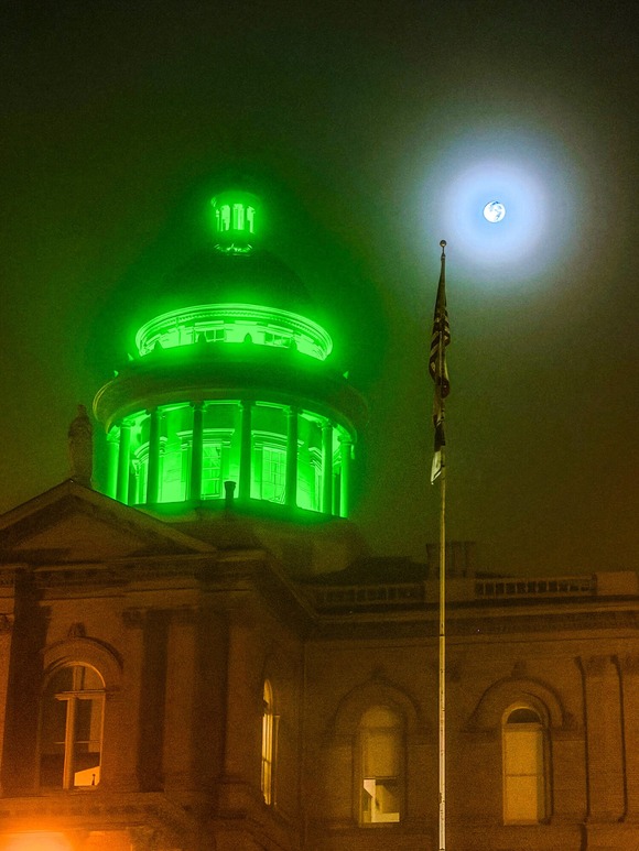 Courthouse lit up in green