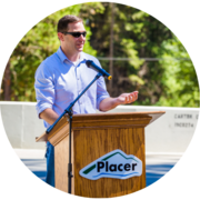 An image of Matt Randall at a podium speaking.