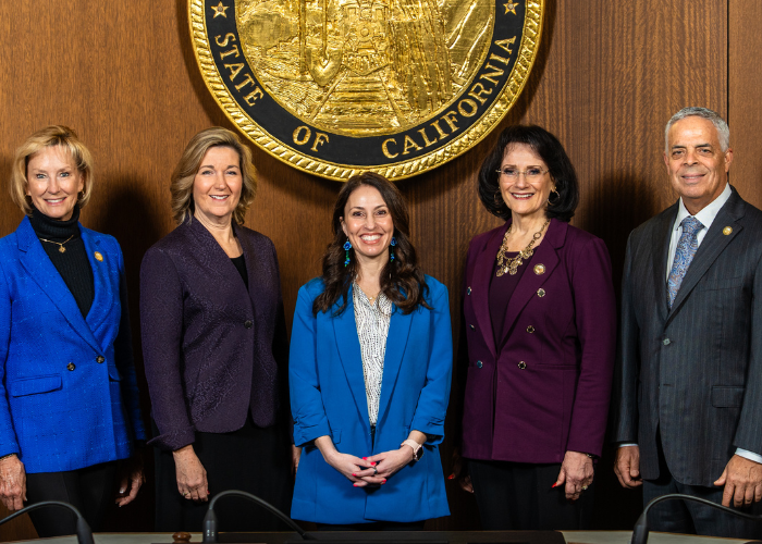 Placer County Board of Supervisors standing in front of the county seal with Board Chair Shanti Landon in the middle