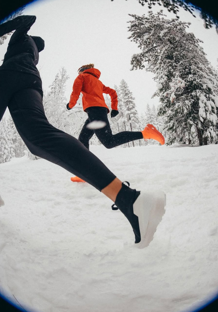 runners in the snow with fisheye lens effect on the photo