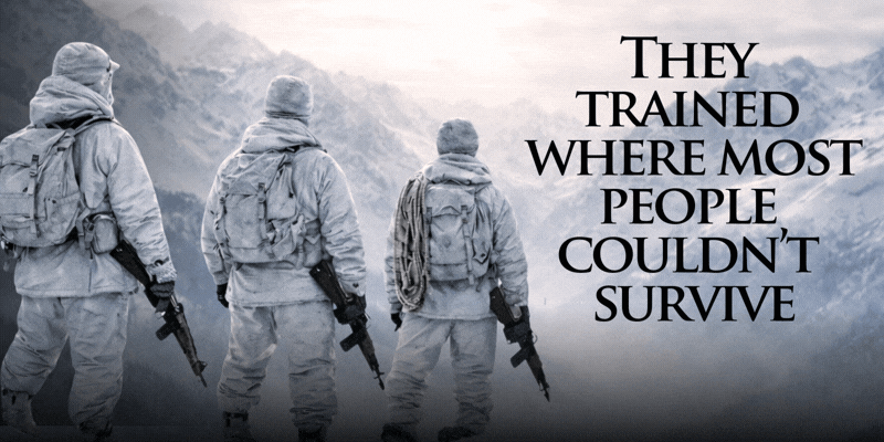3 soldiers dressed in winter fatigues look over the snow-covered Italian alps