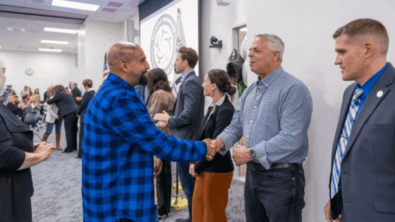 Animated graphic alternating between a photo of two men shaking hands and a group photo set in a conference room