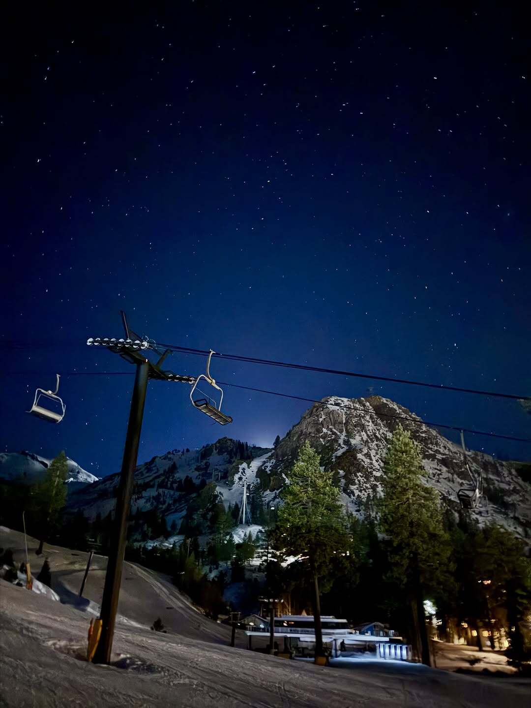 Photos of a ski lift with a mountain and the stars in the background