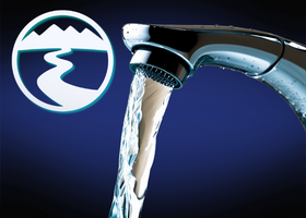 Water pouring from a faucet, the Nevada Irrigation District logo in the background.