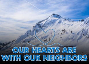 A mountain covered in snow with blue text: Our hearts are with our neighbors