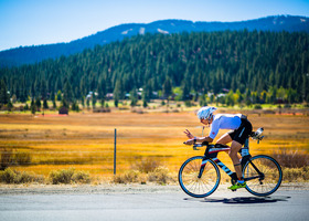 Cyclist on an unincorporated Placer County road with a field and trees in background