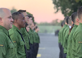 Two lines of sheriff deputy recruits standing at attention while in training