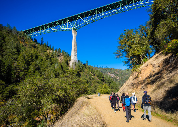 People walking under Foresthill Bridge