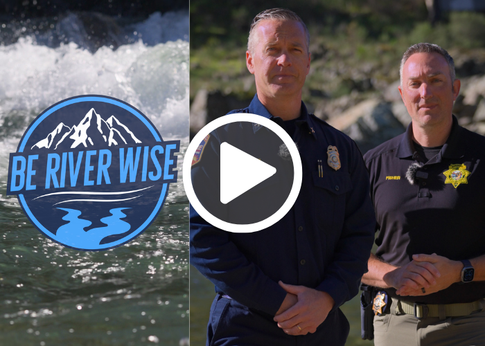 River white water with a Be River Wise logo, Man dressed in a dark blue uniform stands next to another man in a black polo shirt