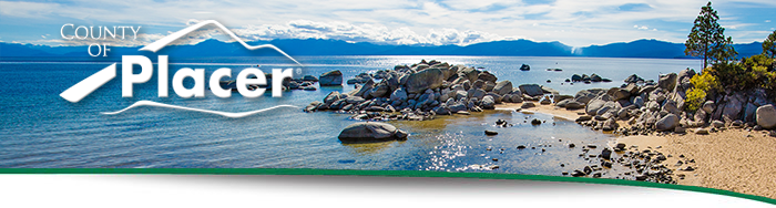 Image of Lake Tahoe from Kings Beach with rocks in the water and sand.