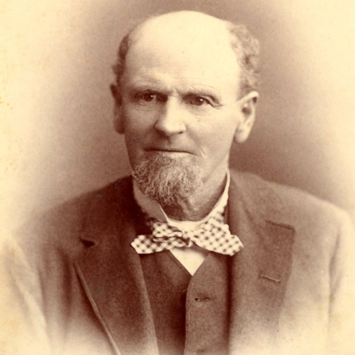 Serious-looking man dressed in a suit and bowtie