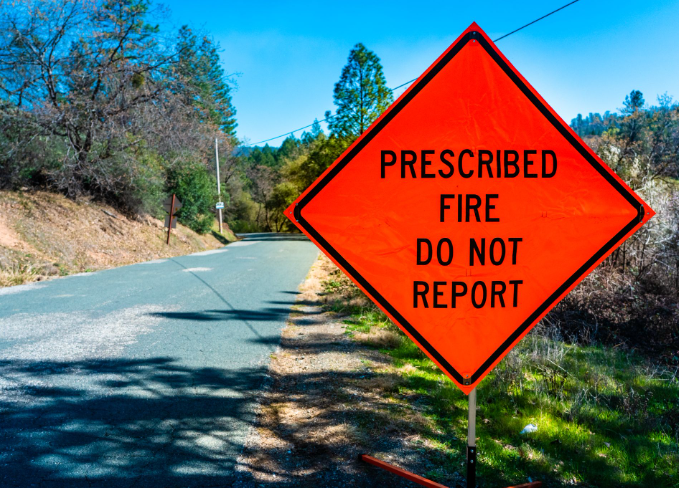 Prescribed fire do not report road sign
