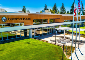 The front entrance of the Placer County Elections office in Rocklin with flag poles lining the entryway